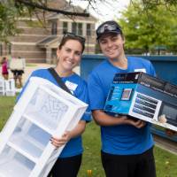 Two volunteers standing together and smiling for camera
